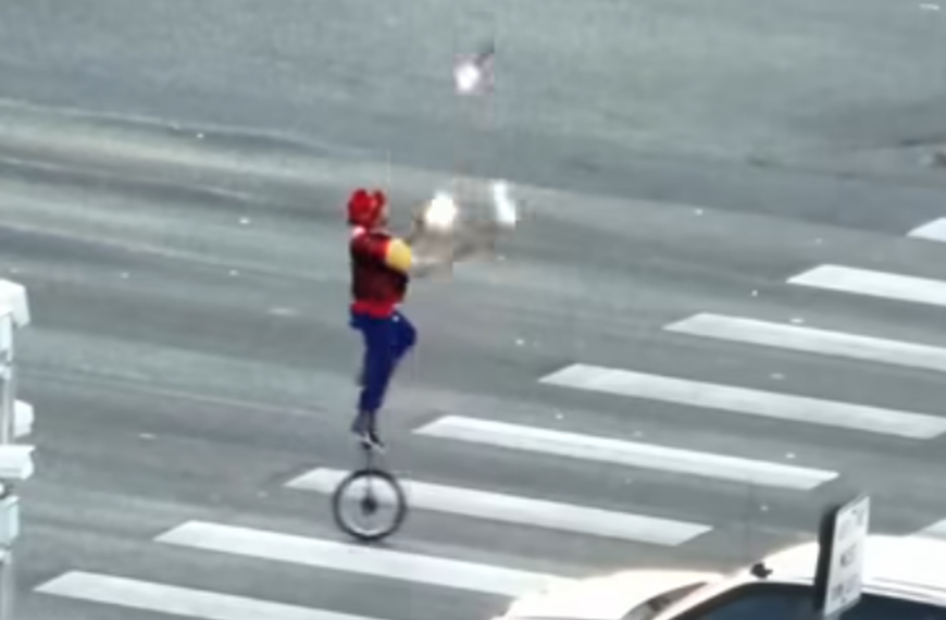 Fire-juggling unicyclist caught performing on crossing